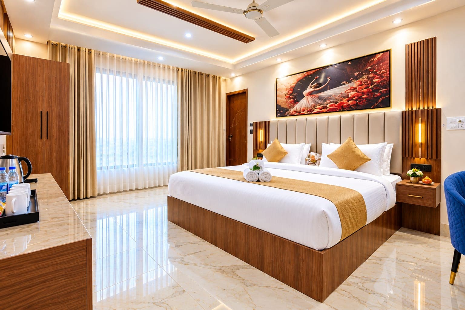 Deluxe guest room with wide window, sheer drapery, and seating corner