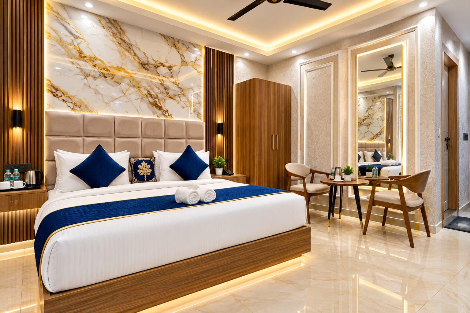 Seating lounge inside deluxe room with contemporary chairs, table, and floor-level bed illumination